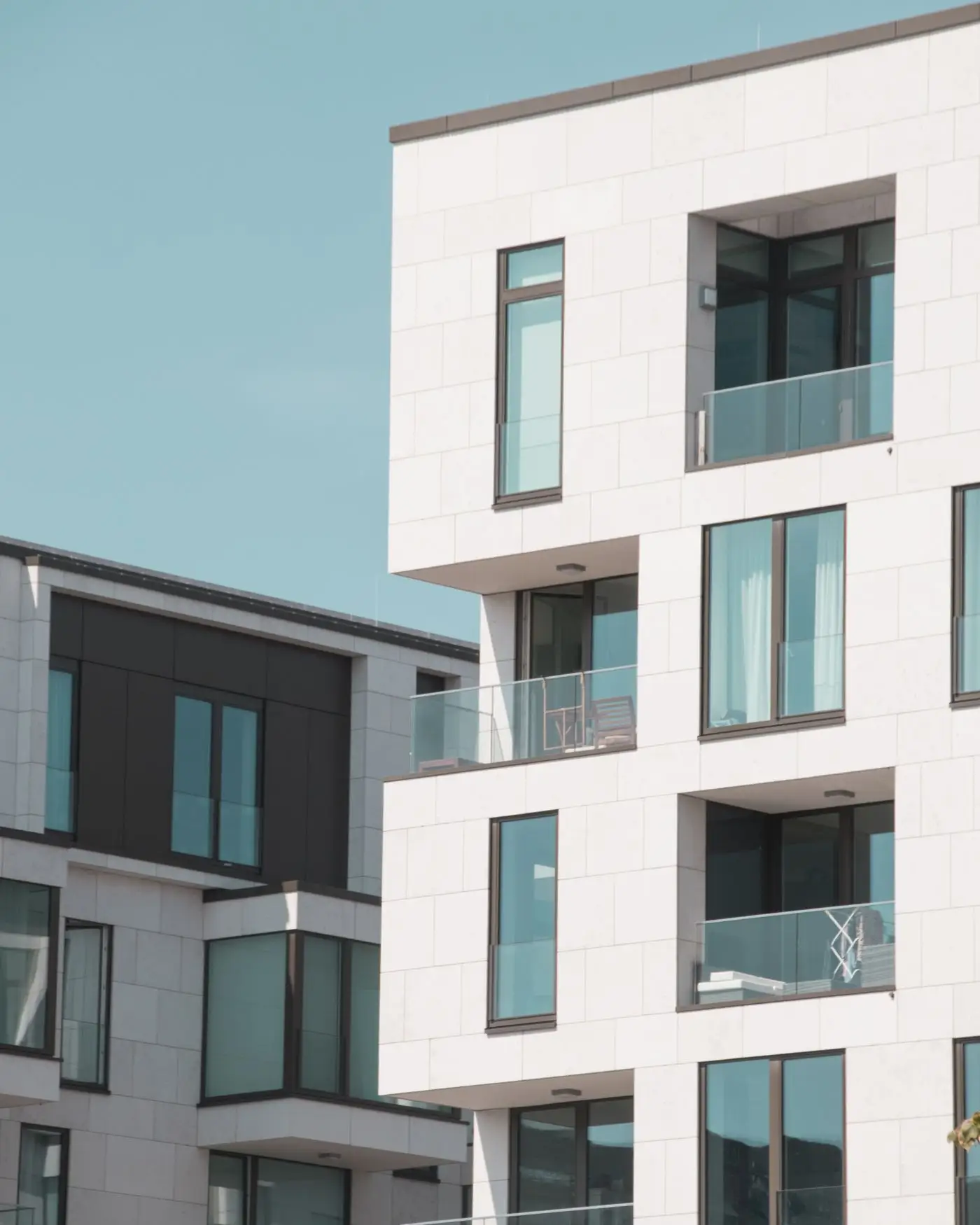White apartment buildings with glass balconies.