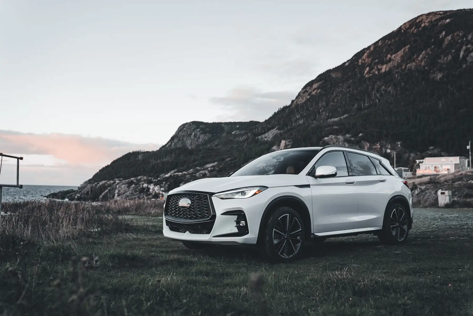 White SUV against the mountains.