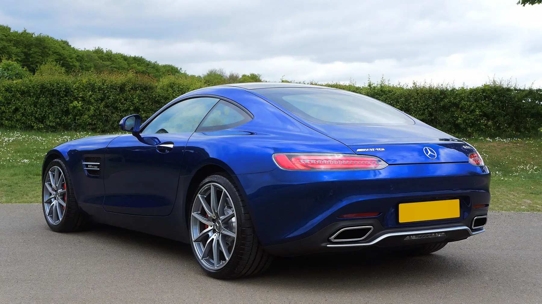 Blue sports coupe in the countryside.