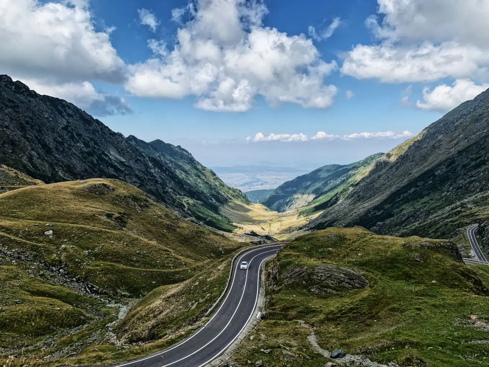 Winding road through green mountains.