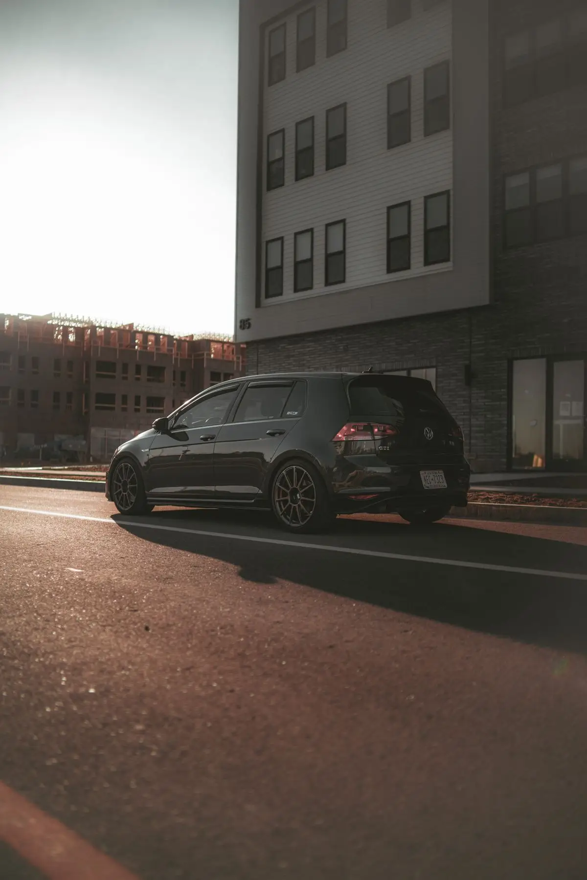 Black hatchback in the city.