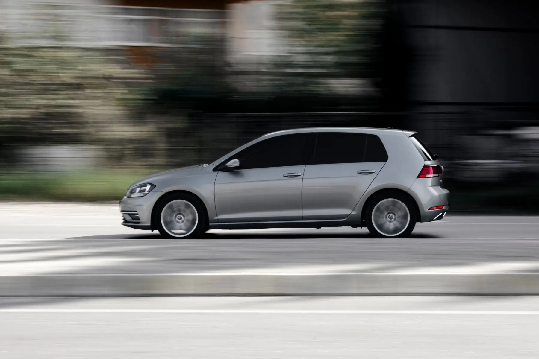 Silver hatchback in motion.