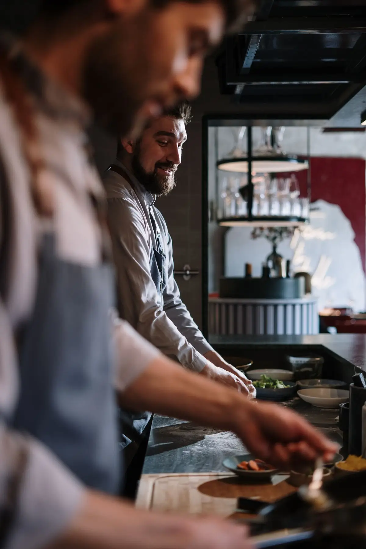 Two chefs plating in the open kitchen.