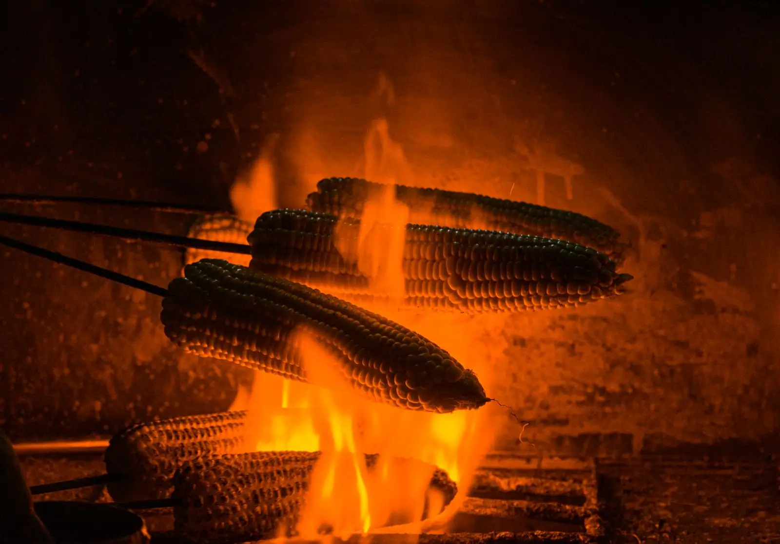Corn roasting over the fire.