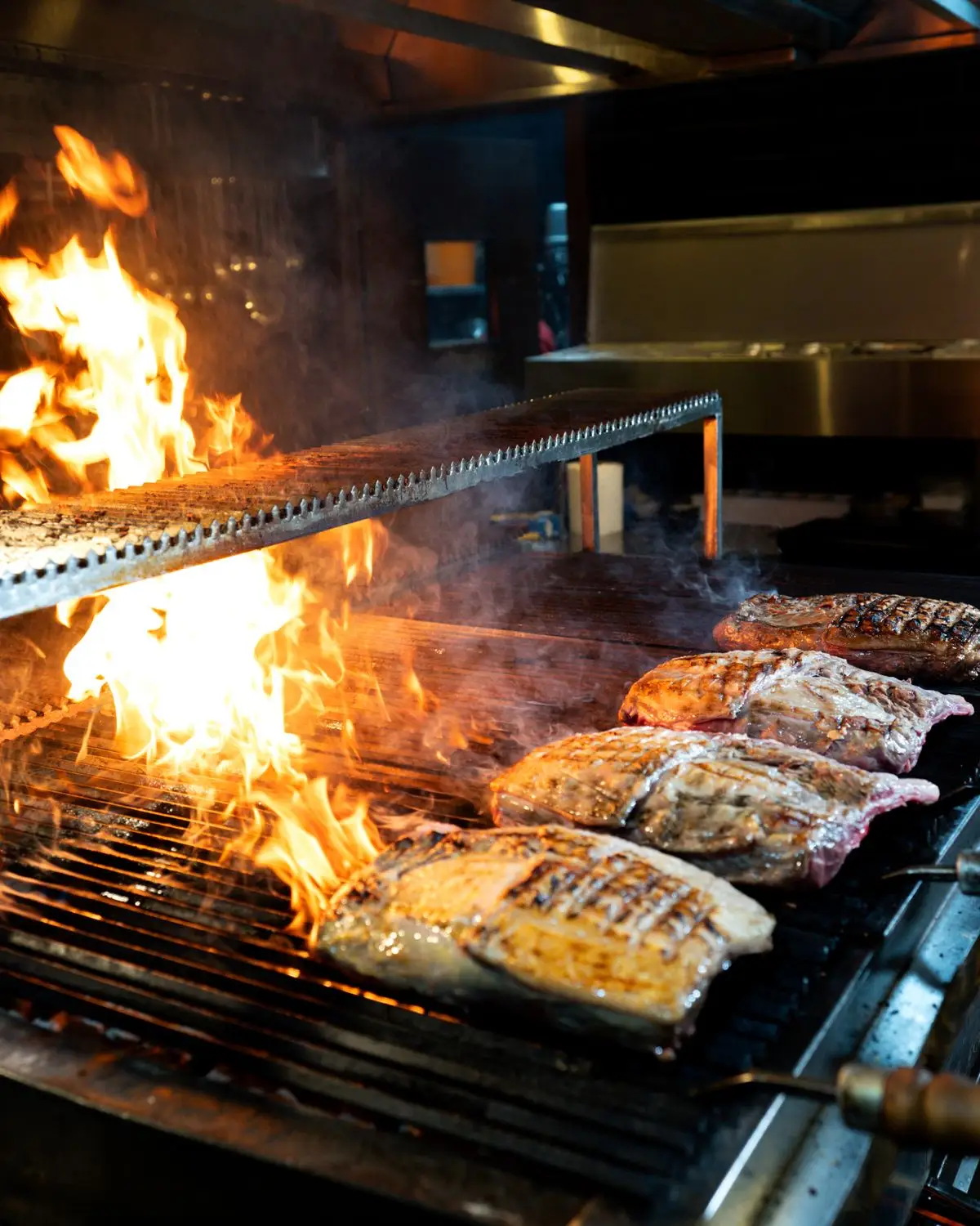 Steaks over an open grill.