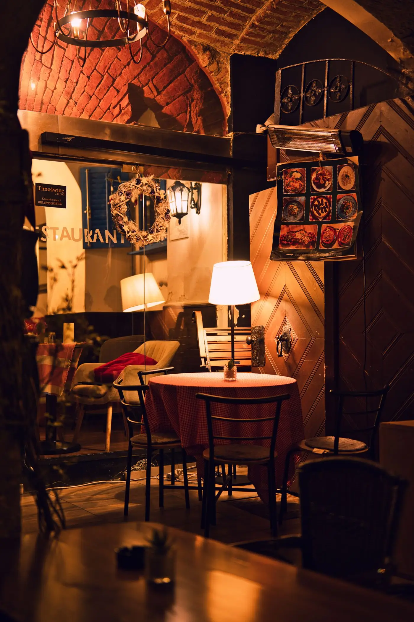 Warm restaurant interior with brick arches.